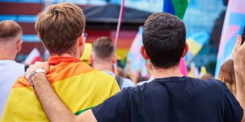 Image for Two young people holding pride flag at school