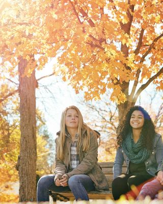 Thumbnail Image for Teens on bench surrounded by fall leaves